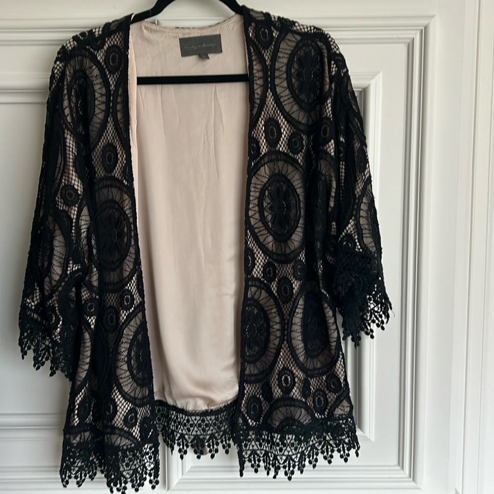 Beautiful lace jacket with satin like fabric underneath. 30 inches long